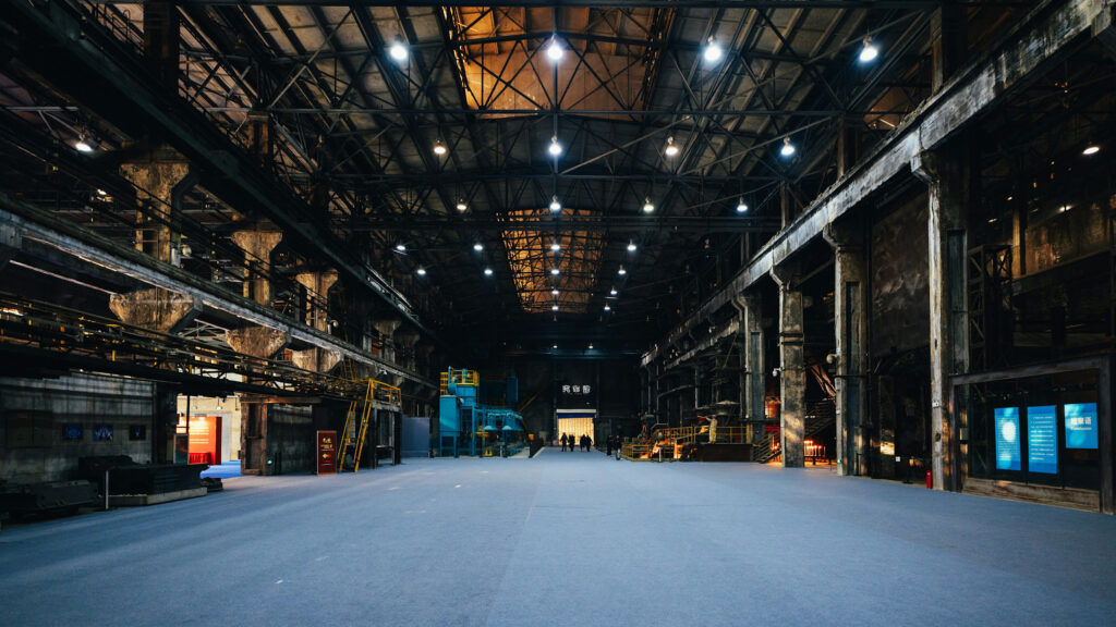Industrial production hall in warm evening light — symbol for Hybris migration in B2B manufacturing