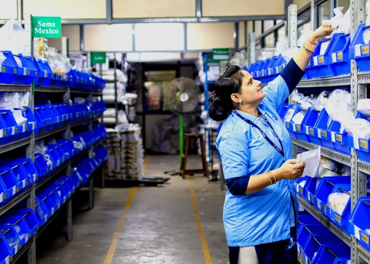 Warehouse employee taking small parts from labelled bins — visual for AI product descriptions from PIM attributes