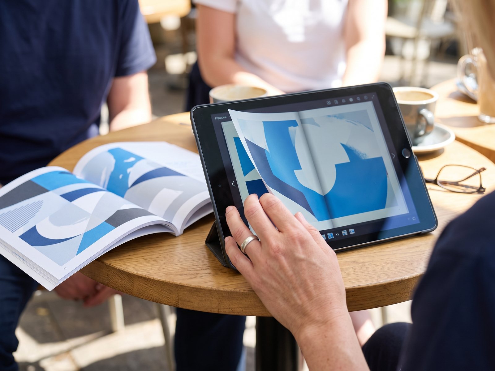 Digital flipbook catalogue on a tablet next to the print