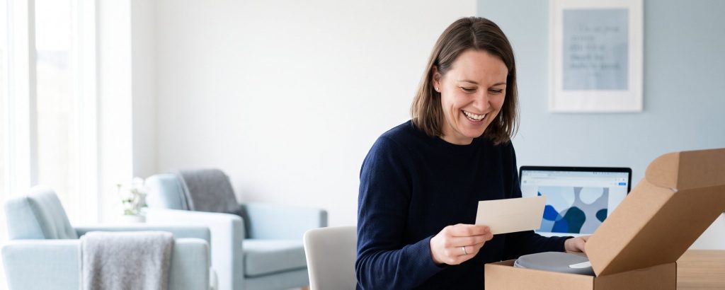 Customer opening a parcel with a personal thank-you card