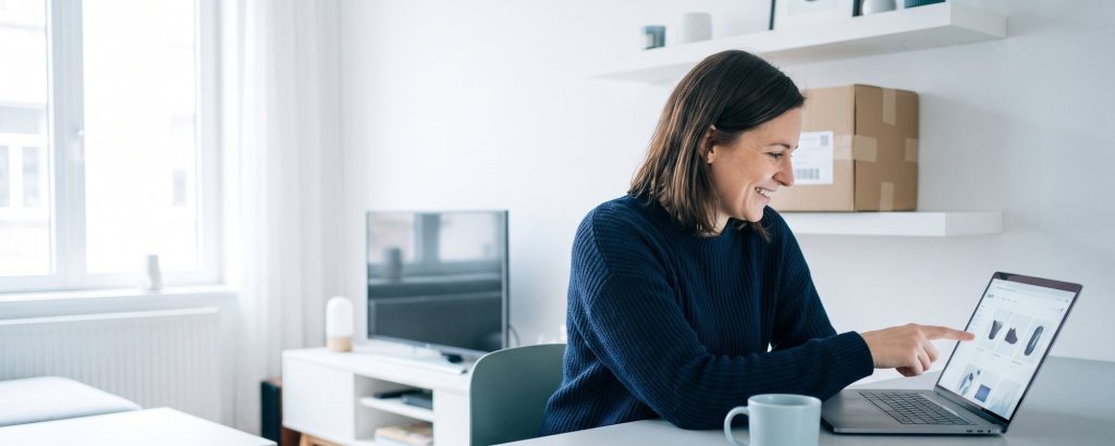 Woman adding a product to her cart in an online shop