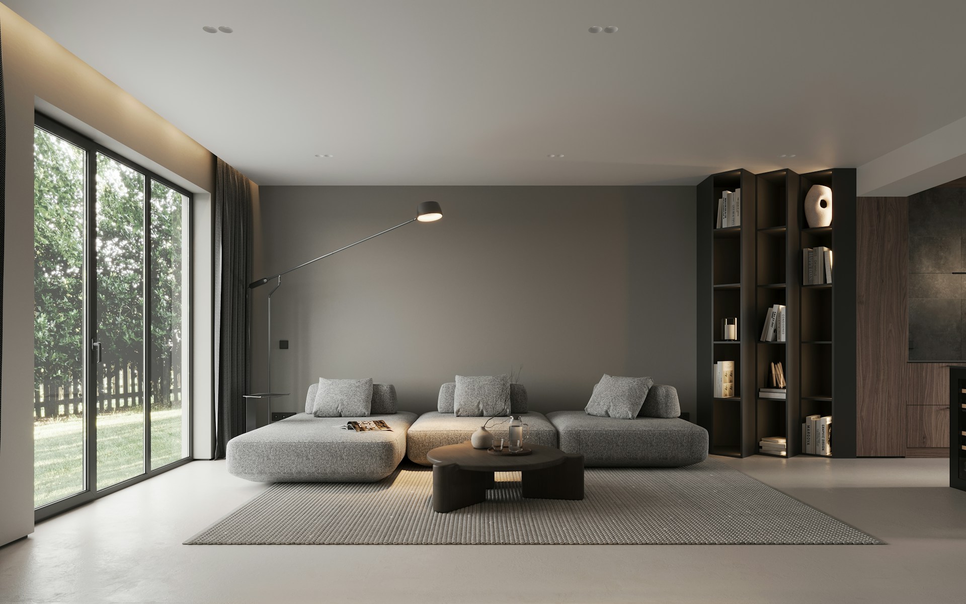 Modernes Wohnzimmer mit grauem Modulsofa, rundem Couchtisch und Fensterfront zum Garten – SEGMÜLLER Success Story